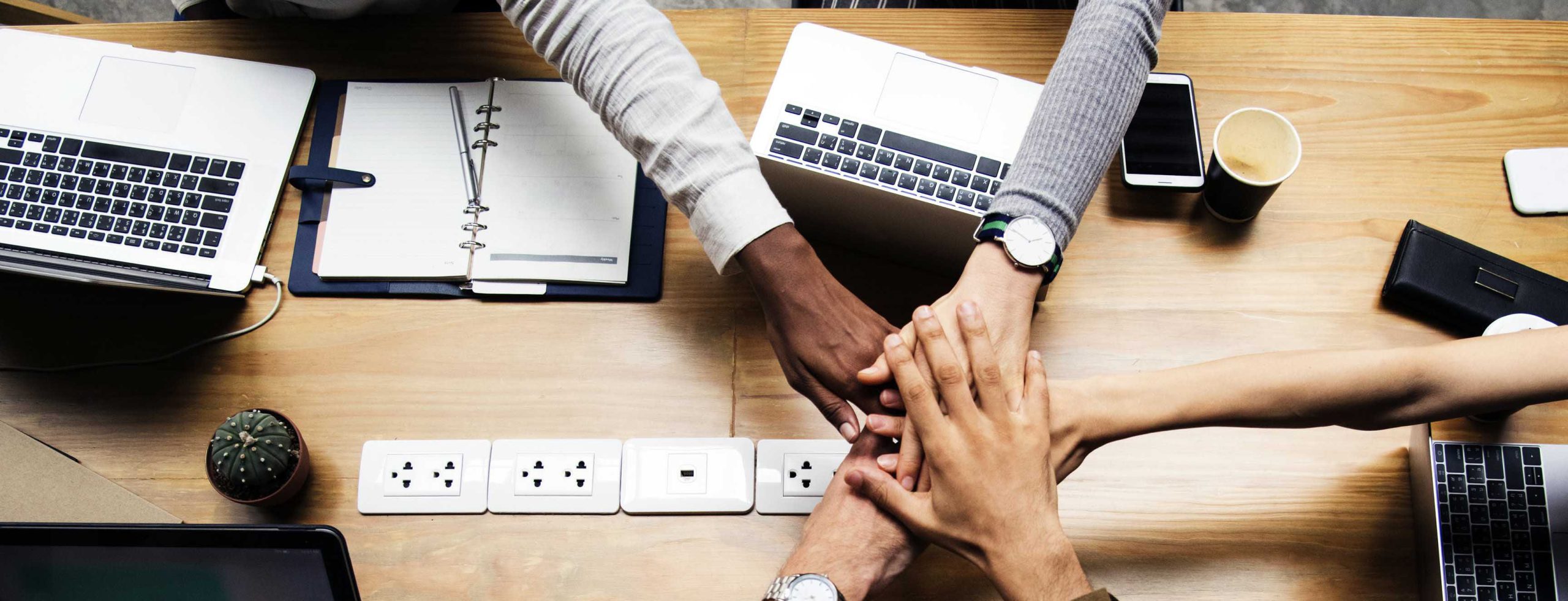 Team of business people stacking hands